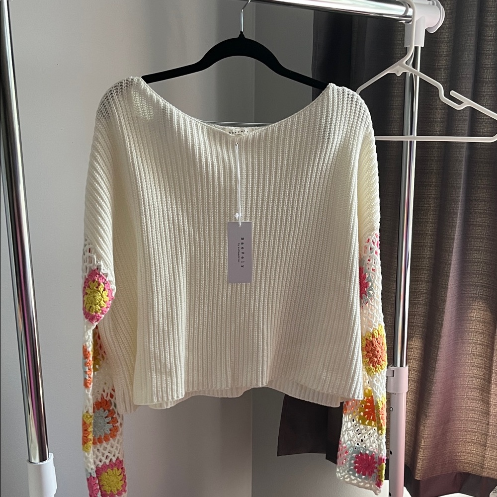 Chic Off-the-Shoulder Cream Sweater with Colorful Crochet Accents